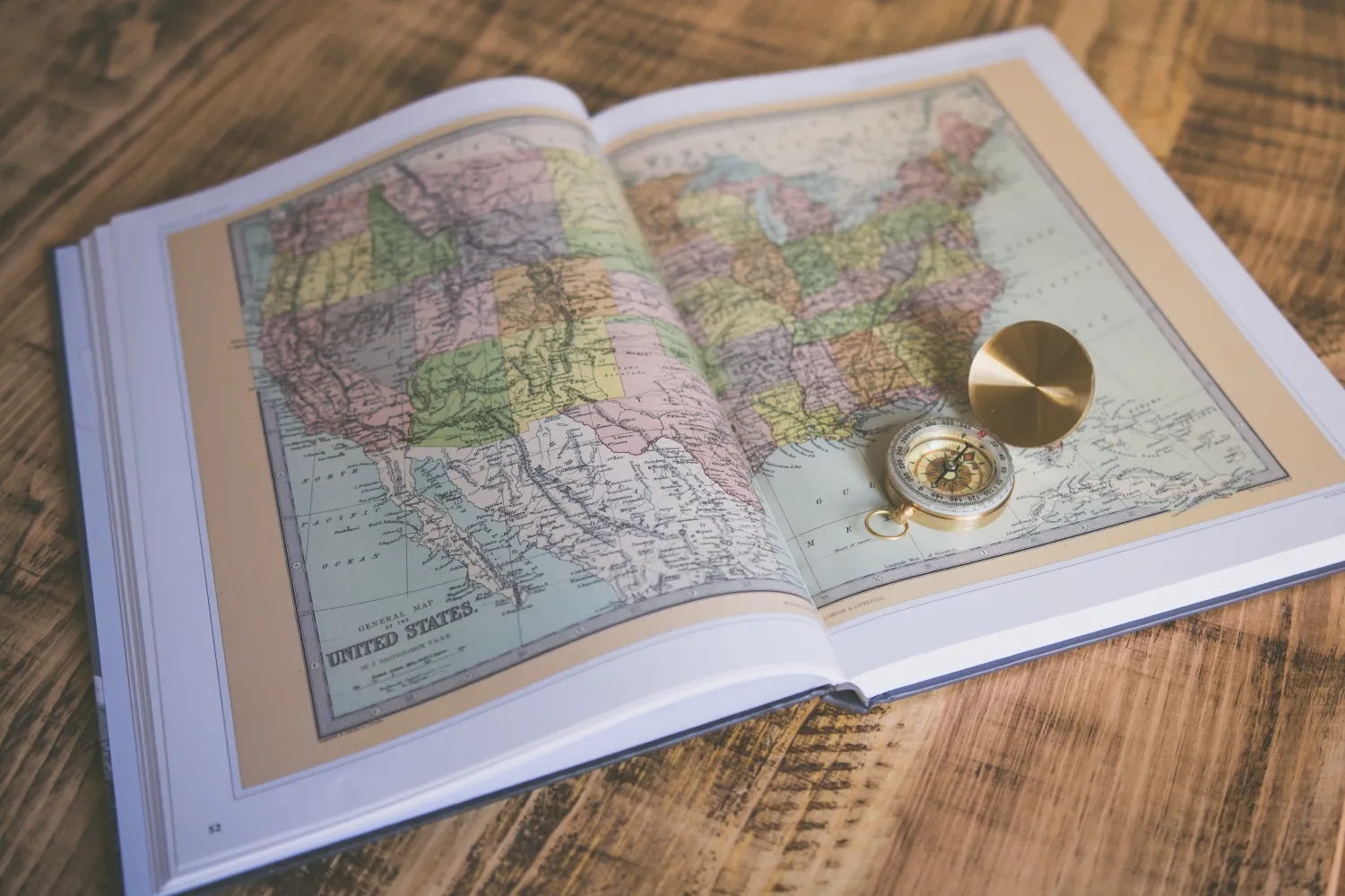 Image of an atlas with a gold compass
